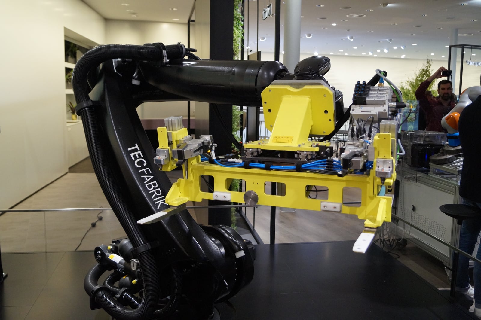Black battery-assembly robot with a yellow gripper at the Mercedes-Benz IAA 2017 stand, archival photograph