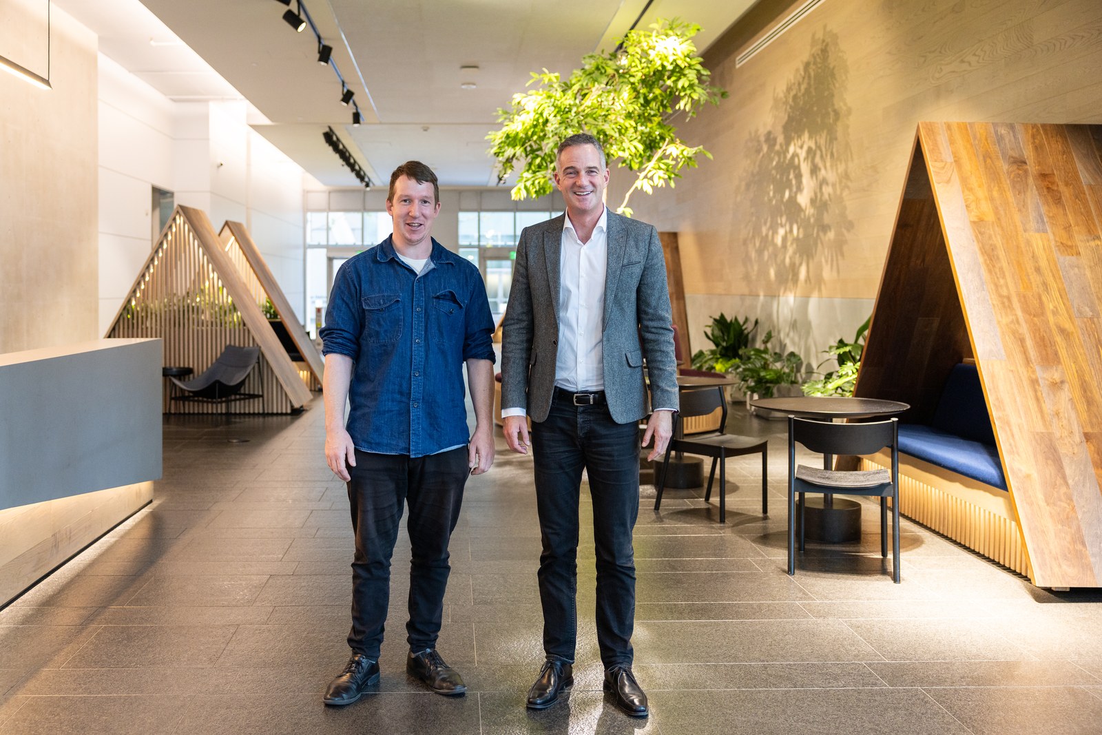 Peter Kyle poses with an Anthropic staff member in a lounge area of the company's San Francisco offices in October 2024