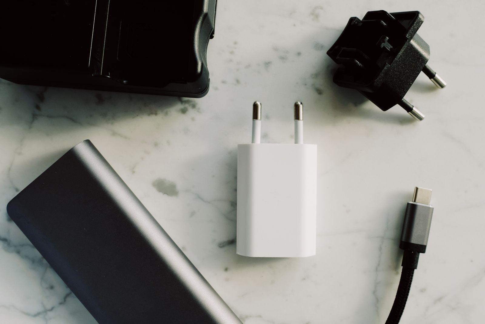 Chargers and adapters beside a USB-C cable on a table