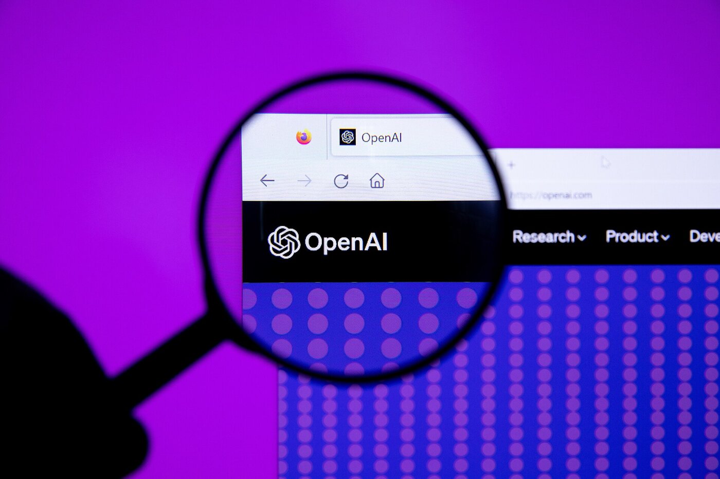 The OpenAI logo seen through a magnifying glass on a purple background