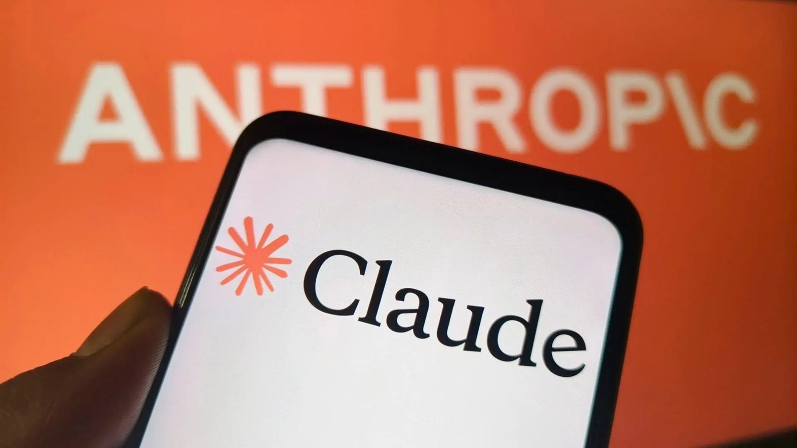A phone showing the Claude logo in front of Anthropic's orange logo