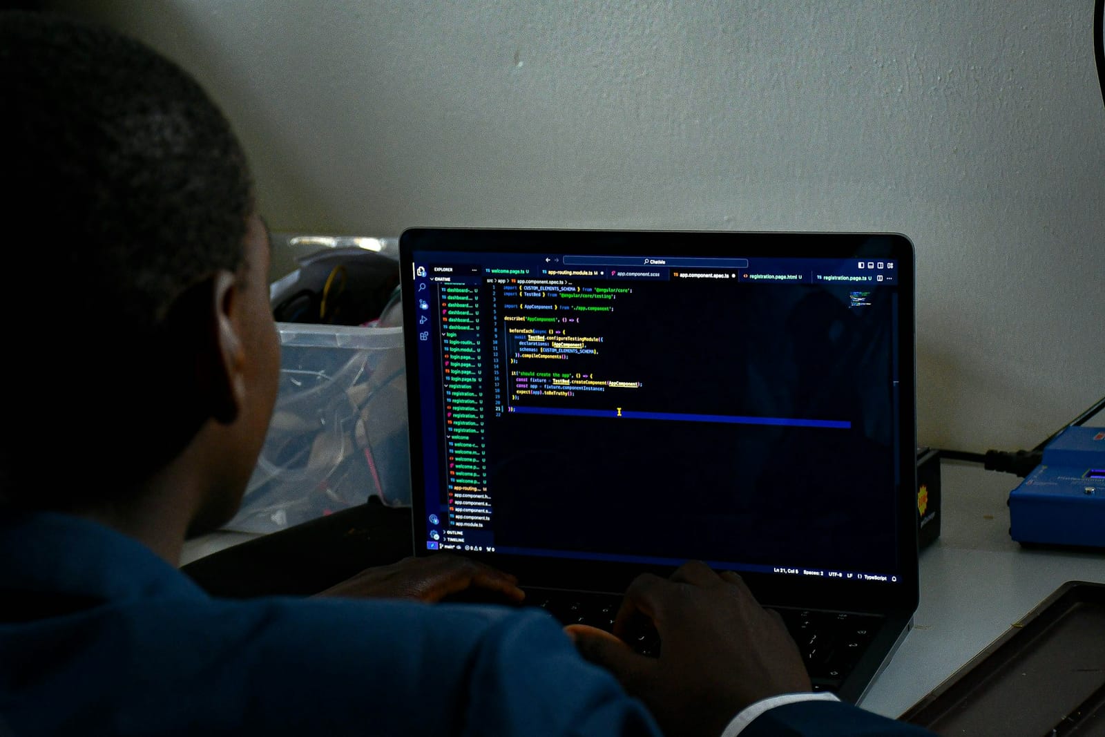 Un programador trabaja ante una pantalla con código en un ordenador portátil
