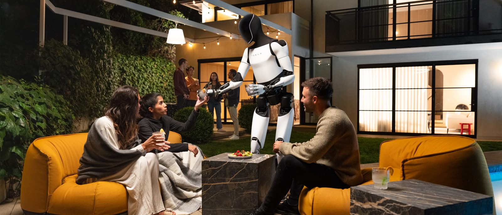 Tesla's Optimus humanoid robot serves a drink during the We, Robot event