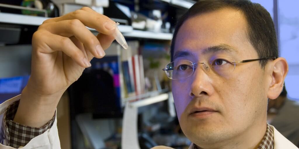Shinya Yamanaka holds a sample inside his laboratory