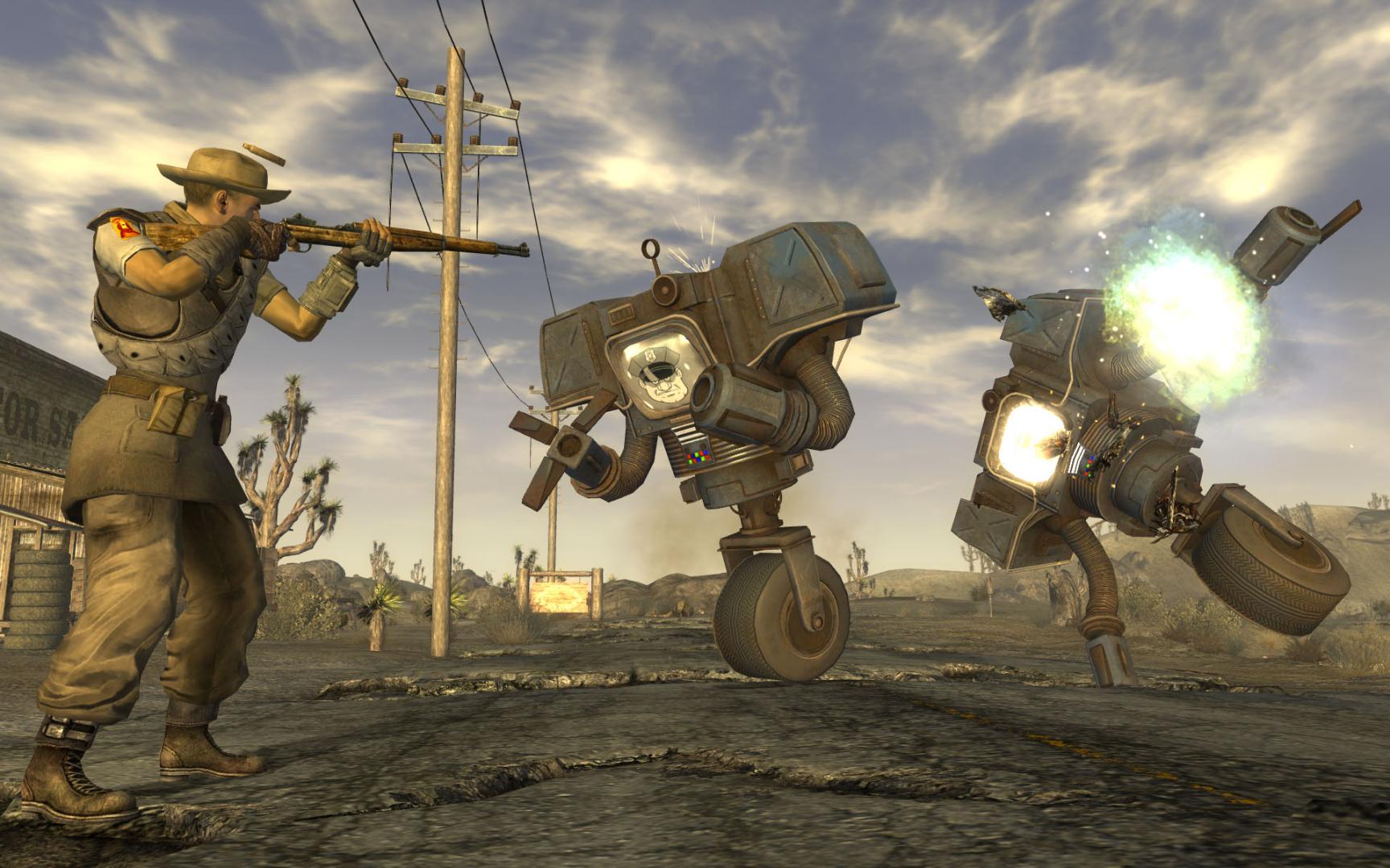 A soldier fires at two robots in the Mojave in an official screenshot from the original Fallout: New Vegas