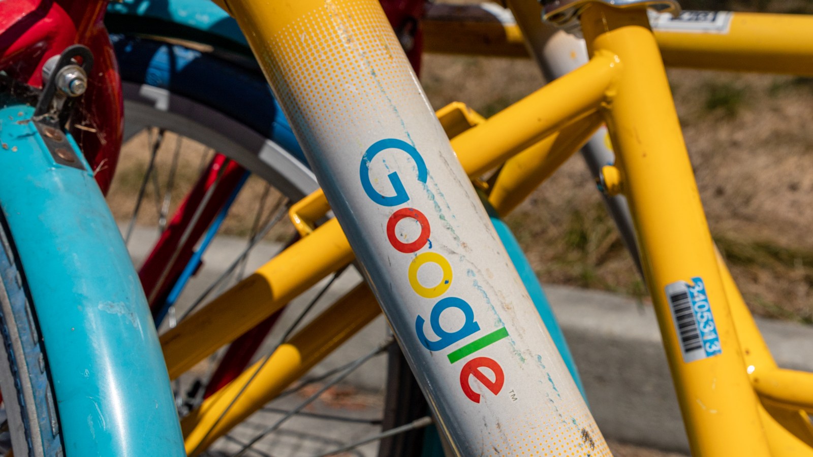 The frame of a yellow Google bike with the company logo, at Google's Mountain View headquarters