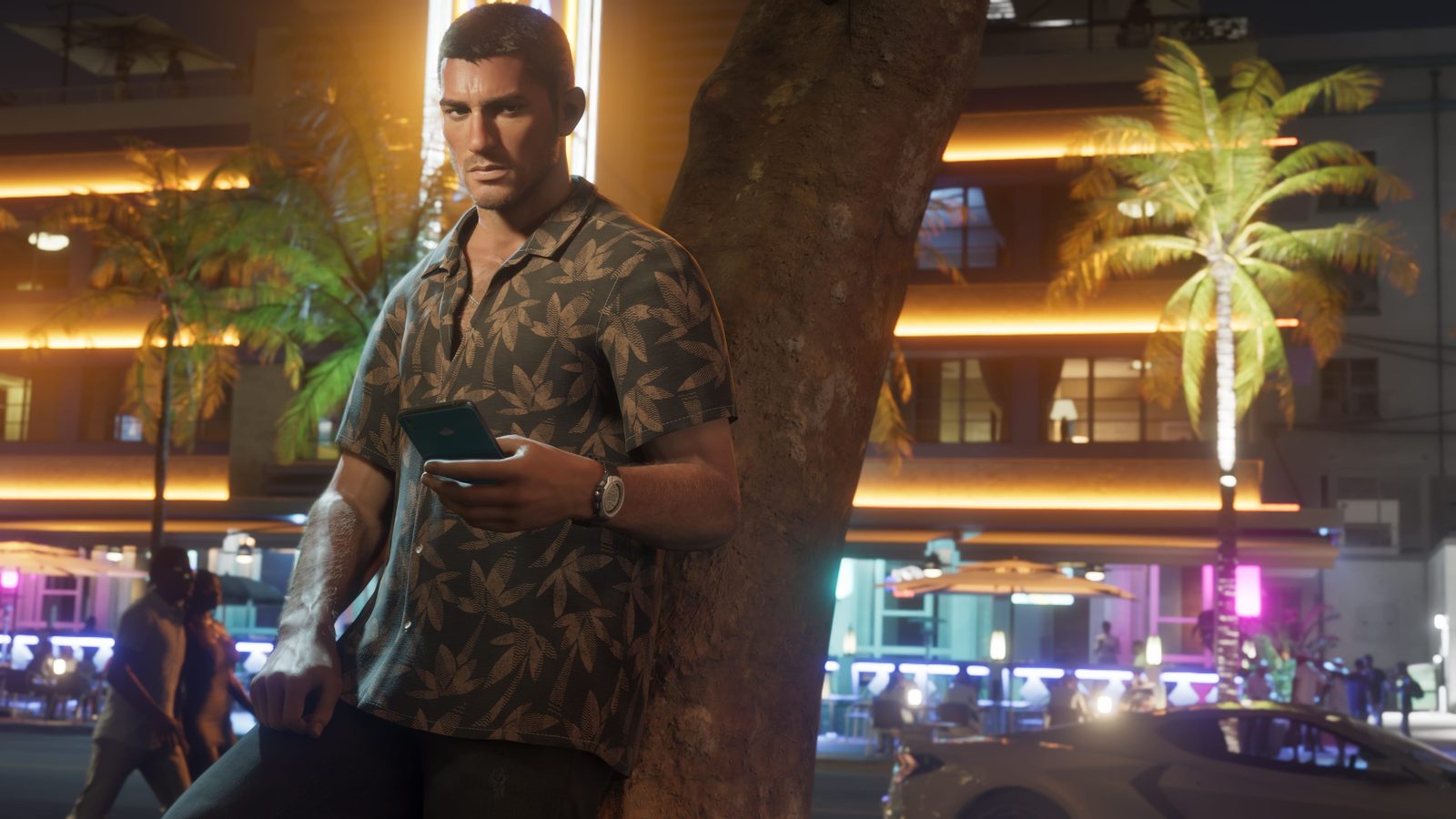 Jason Duval consulta su teléfono en una calle iluminada de Vice City en una captura oficial de GTA 6
