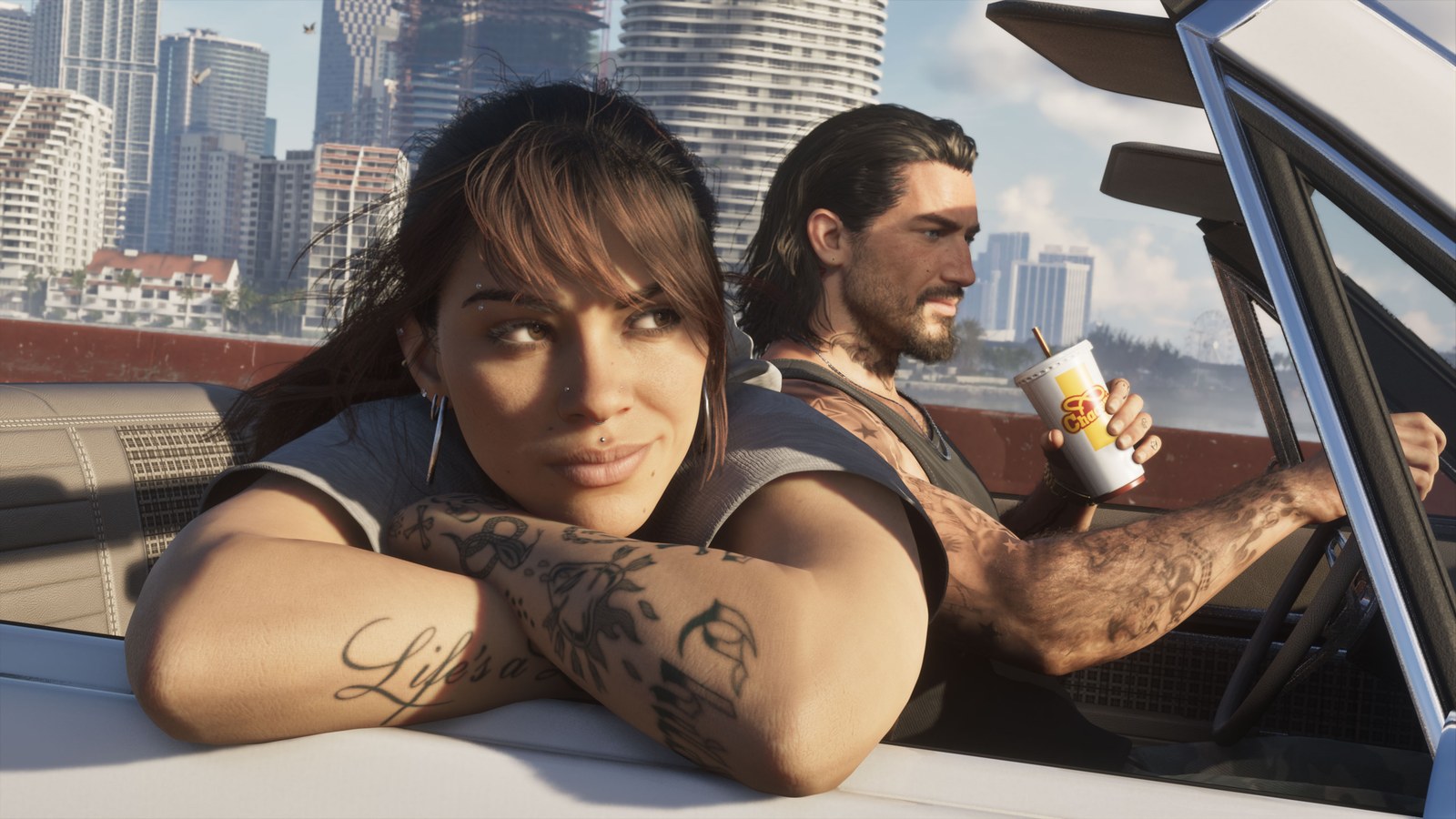 Lucia leans on the door of a convertible while Jason drives holding a cup, with the Vice City skyline behind them in GTA 6