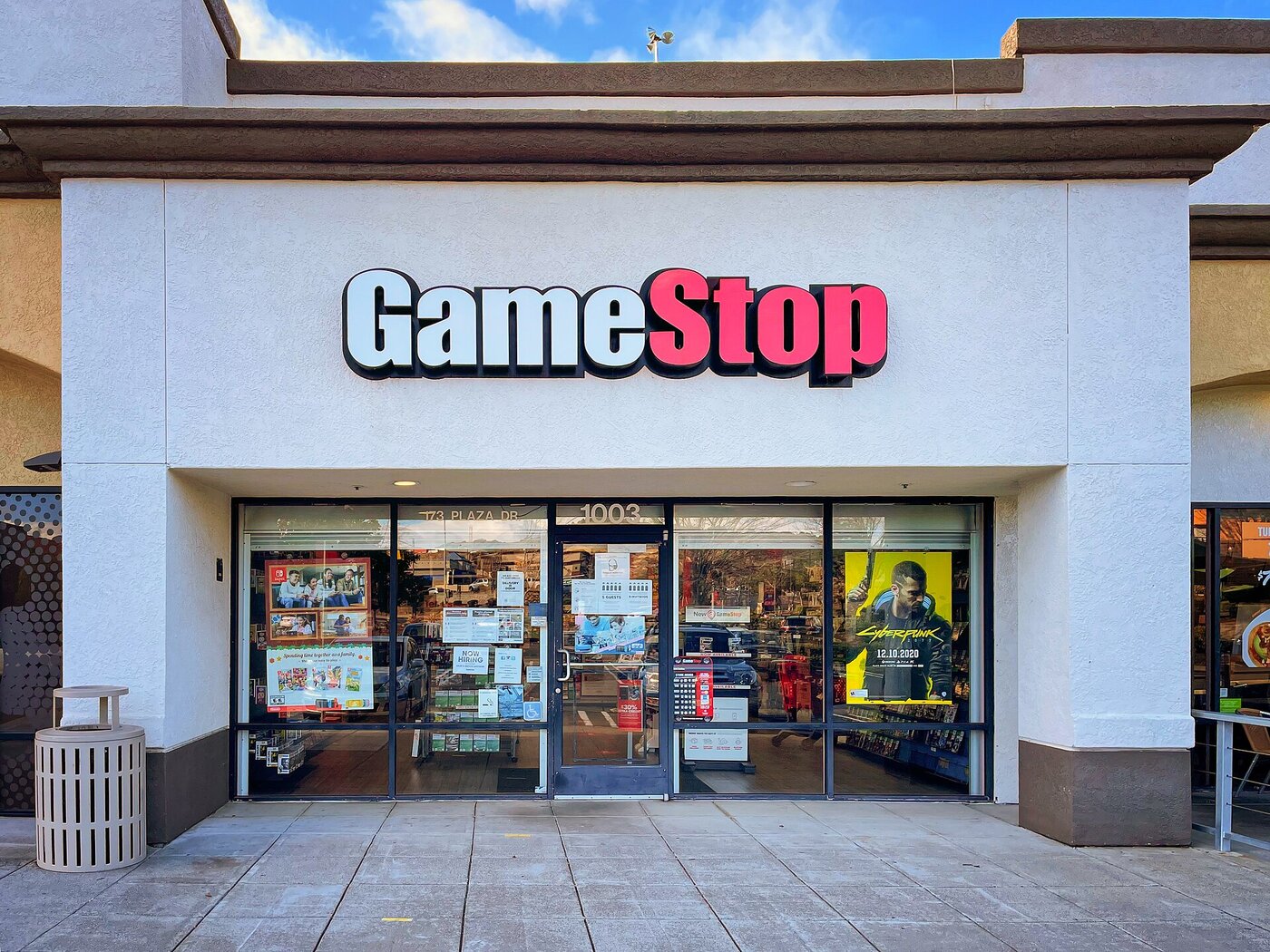 A GameStop storefront with video game posters in the windows