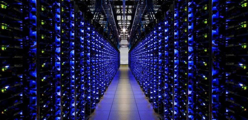 Aisle between rows of blue-lit servers inside a Google data center