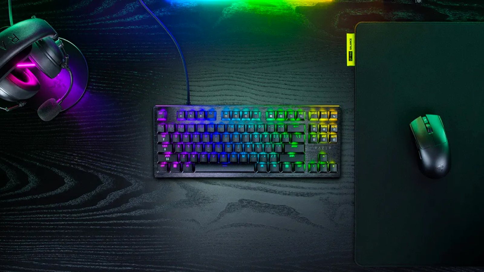 Razer Huntsman V3 HE keyboard beside a gaming mouse and headset