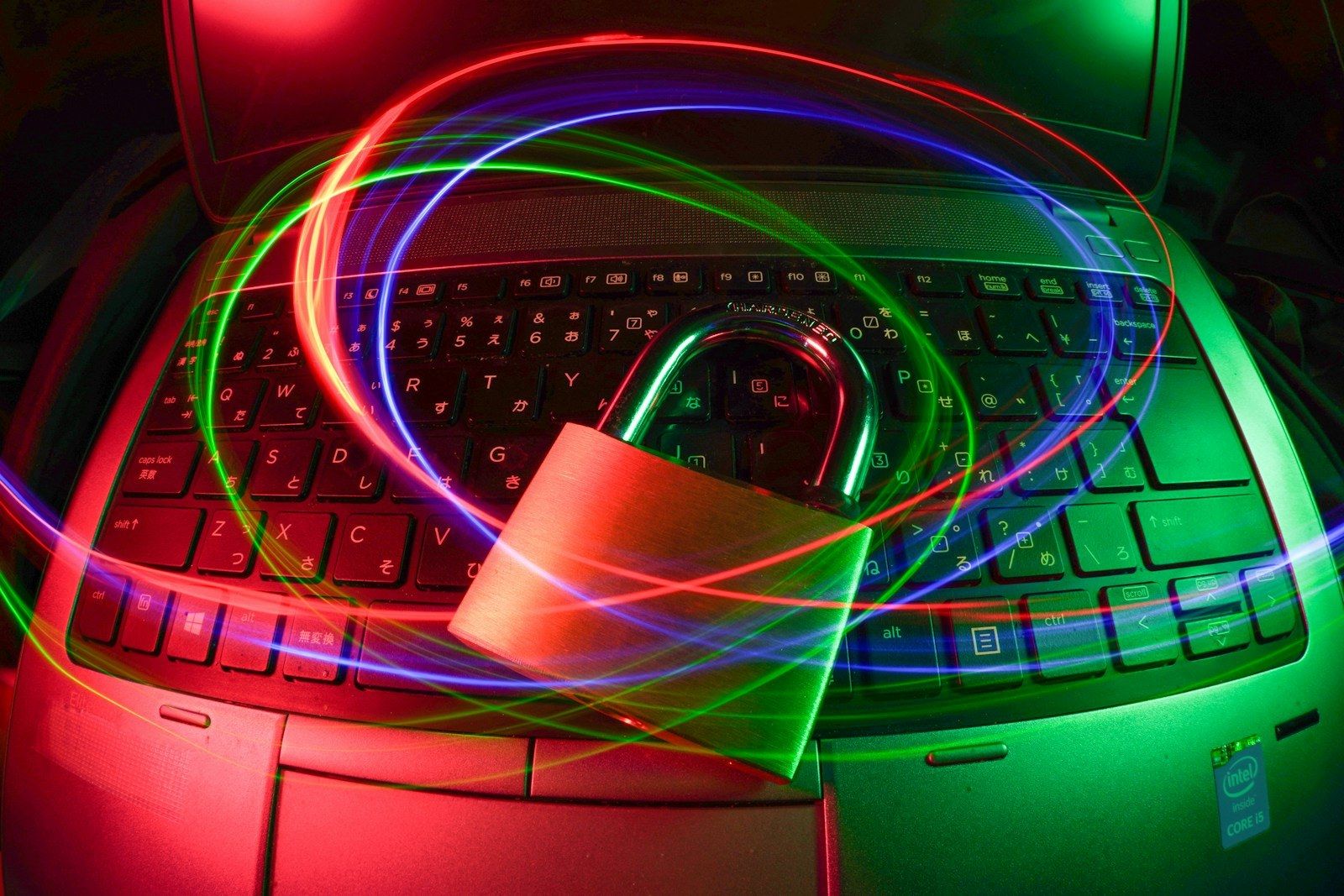 A padlock on a keyboard lit by red and green lights