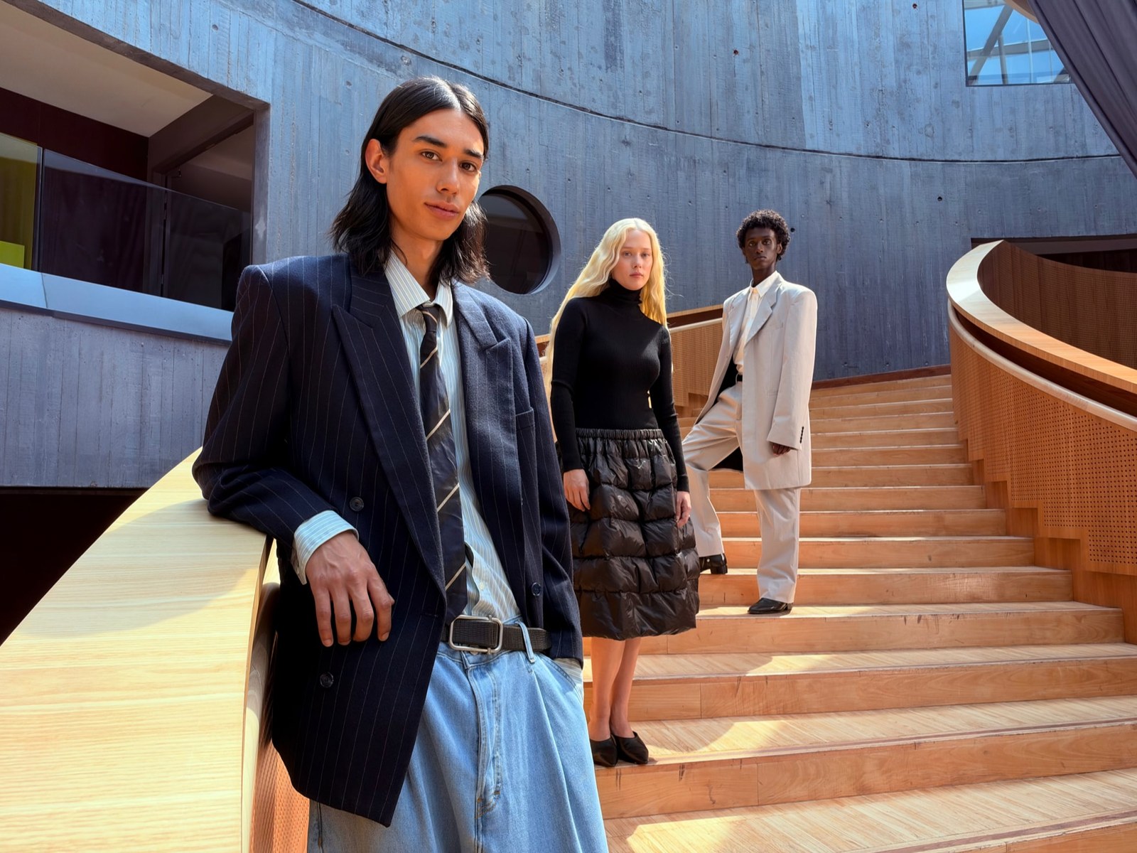 Three people at different distances on a staircase in Apple's iPhone 18 Pro f/4 aperture sample