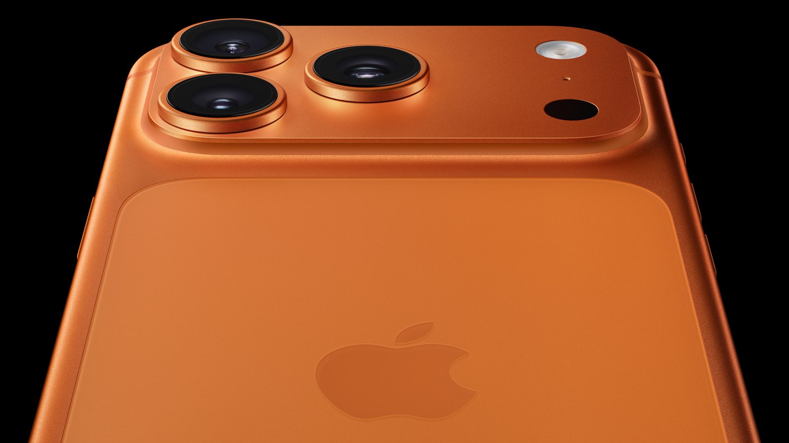Close-up of the three rear cameras on a cosmic orange iPhone 17 Pro