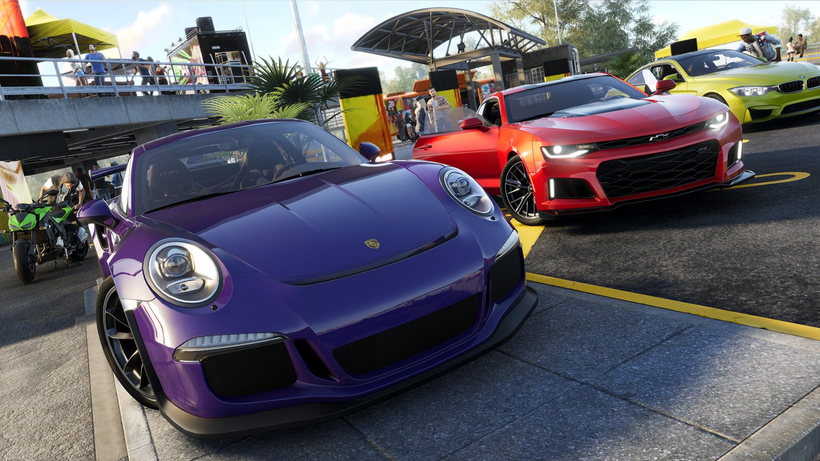 Sports cars gathered beside an urban track in The Crew 2