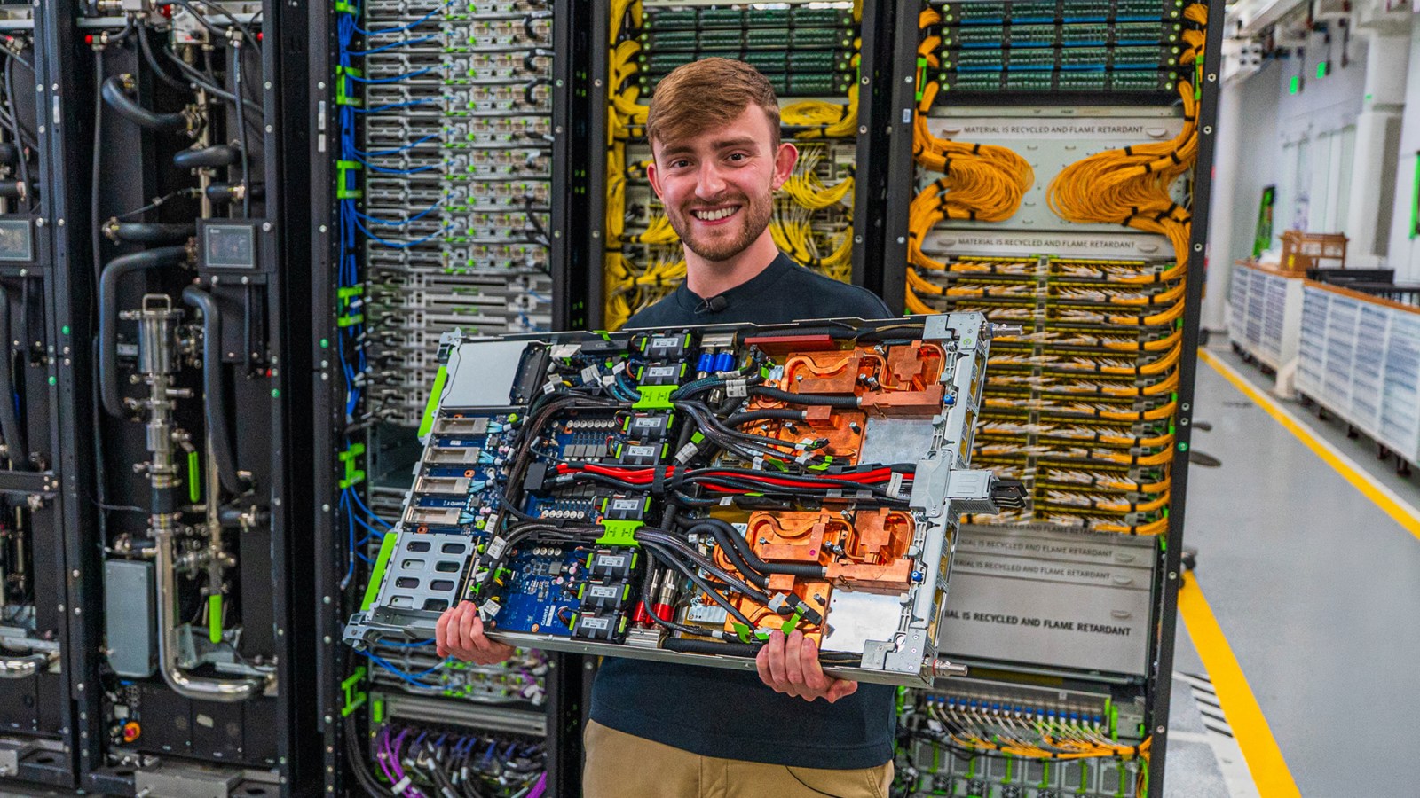 Tom Shaw holds an open server inside Meta's infrastructure lab