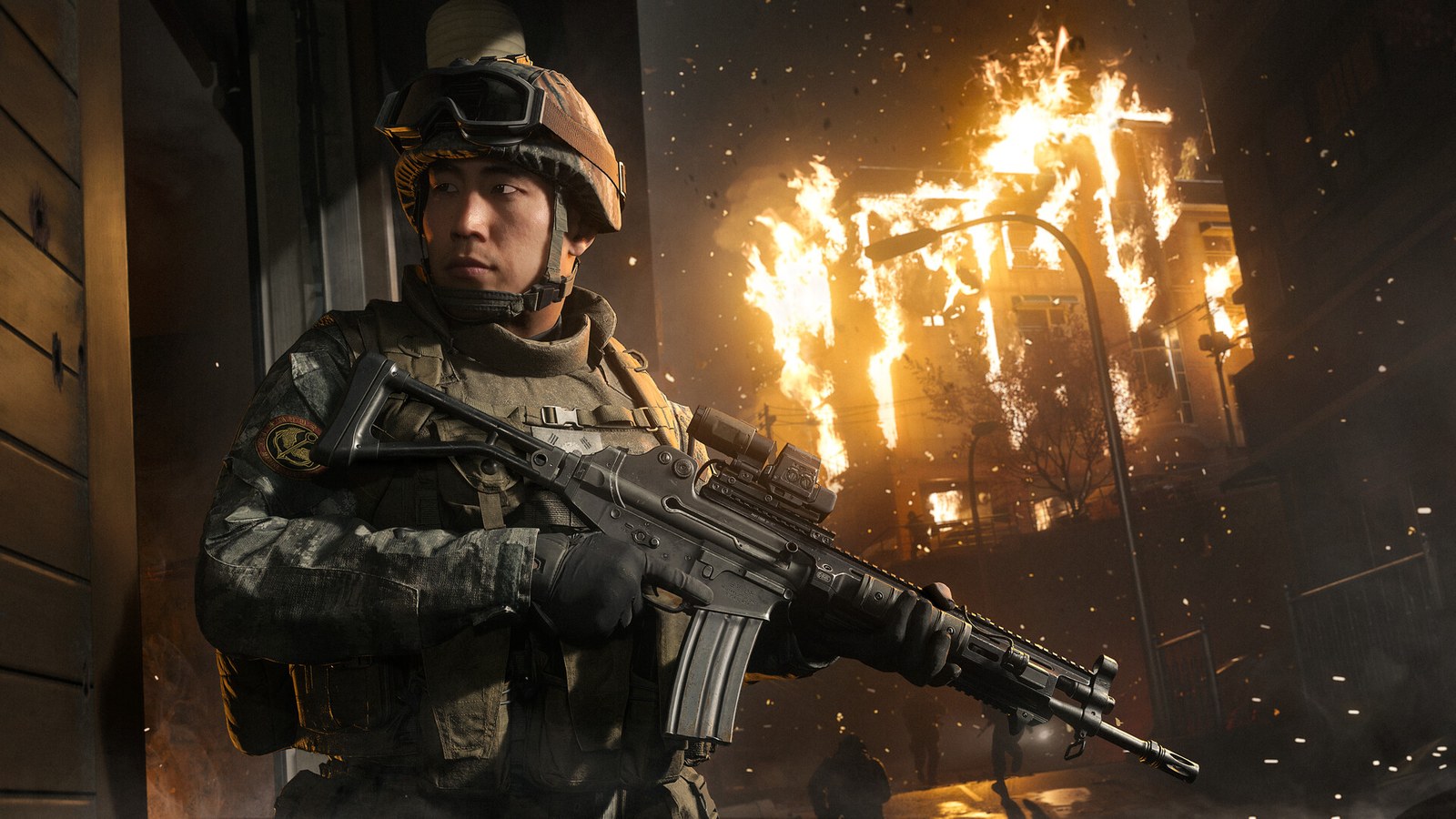 A helmeted soldier holds his rifle in front of a burning building in Modern Warfare 4