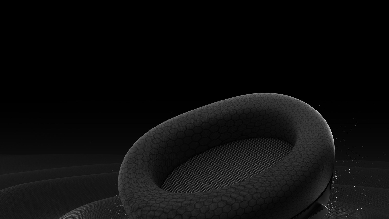 Close-up of a black MSI Maestro 500 Wireless ear cushion, with its hexagon-textured mesh fabric, on a black background
