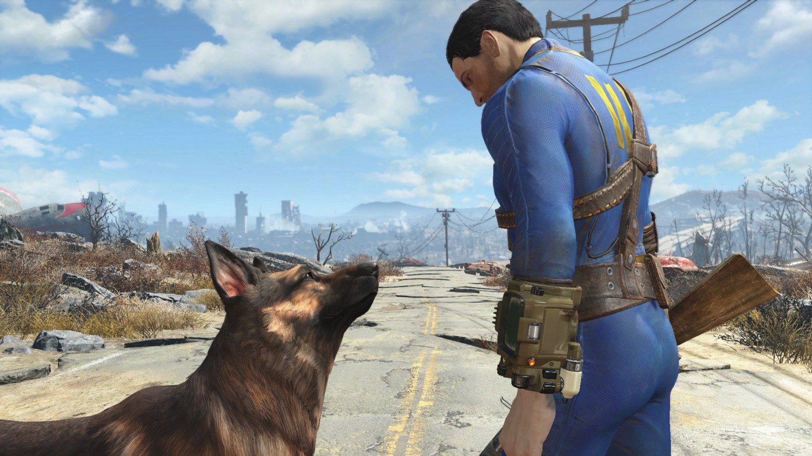 The Fallout 4 protagonist in a blue Vault suit stands beside Dogmeat on a ruined road