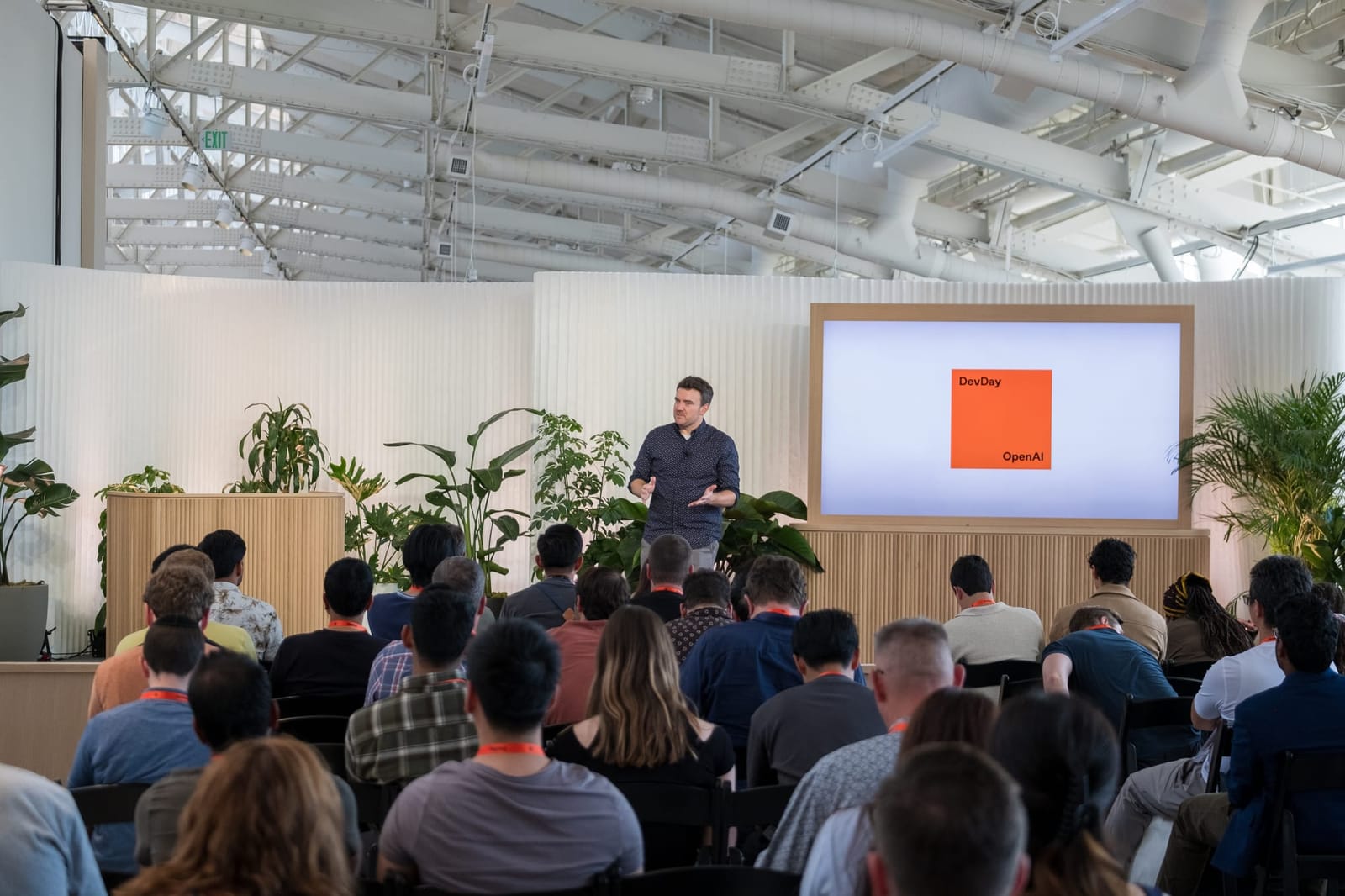 A technical presentation before the audience at OpenAI DevDay 2024