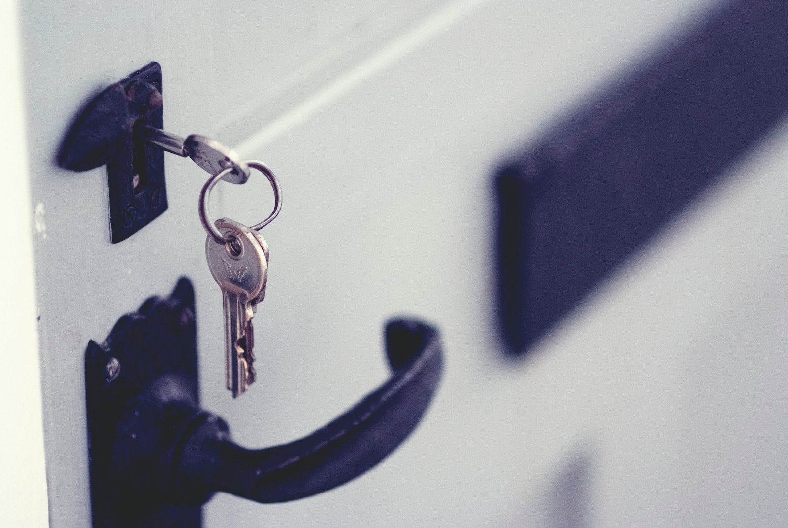 Lock and key on a white door