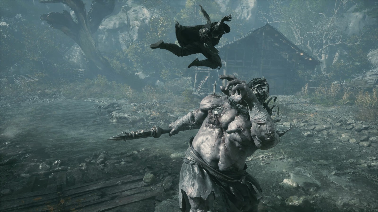 A fighter leaps over a pale-skinned giant during a boss fight in Phantom Blade Zero