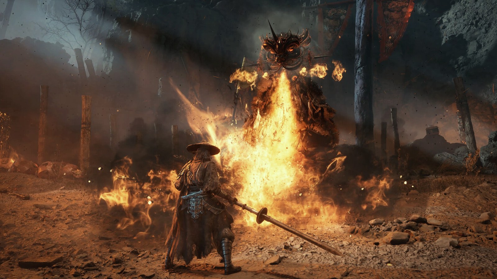 A warrior in a wide-brimmed hat faces an enemy engulfed in flames in a ruined village in Phantom Blade Zero