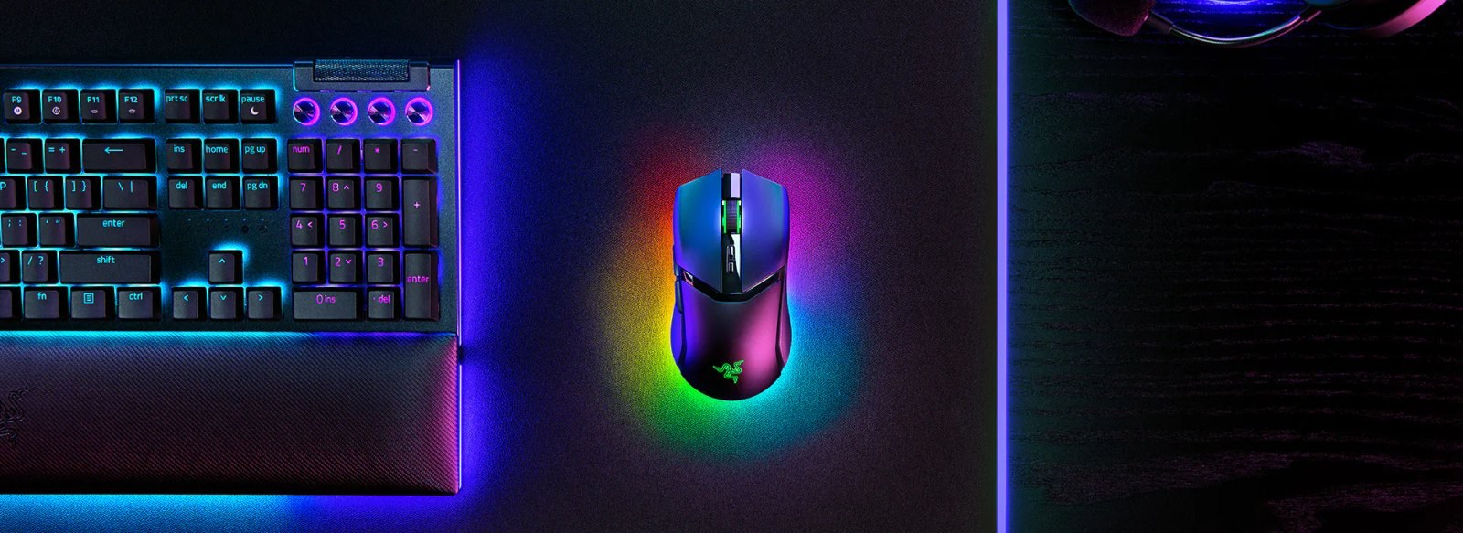 An illuminated Razer Cobra Pro mouse and keyboard on a desk