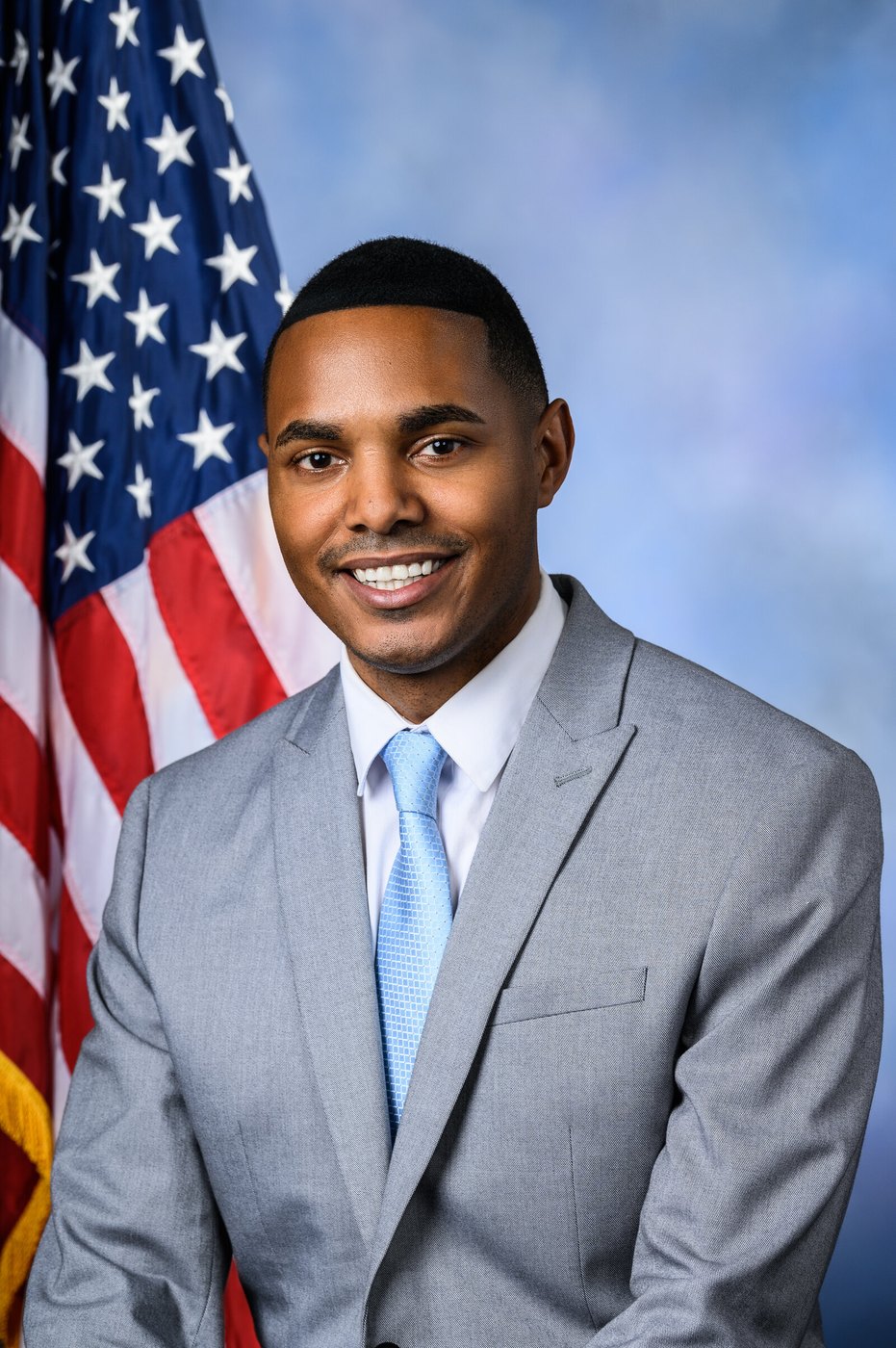 Official portrait of Congressman Ritchie Torres in front of the US flag