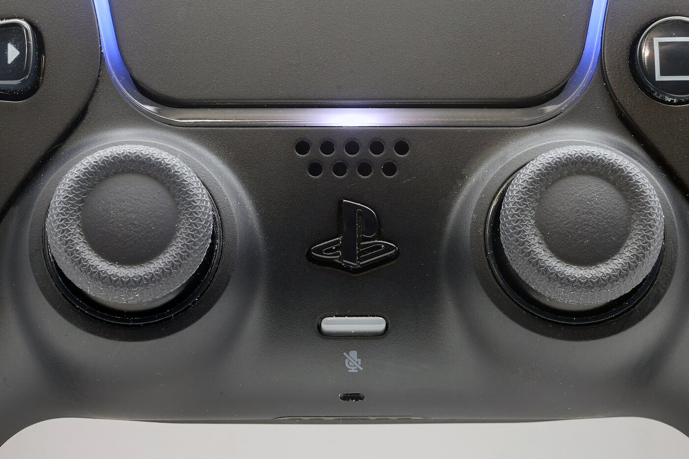 Close-up of a Midnight Black DualSense with the PlayStation logo in the center