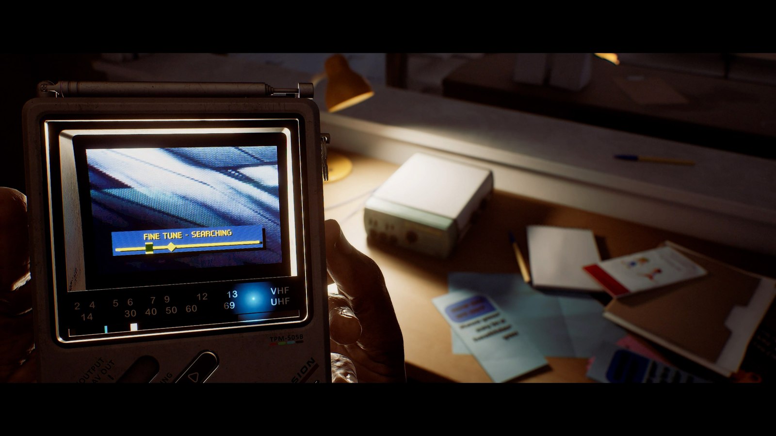 The CRTV examines objects on a desk