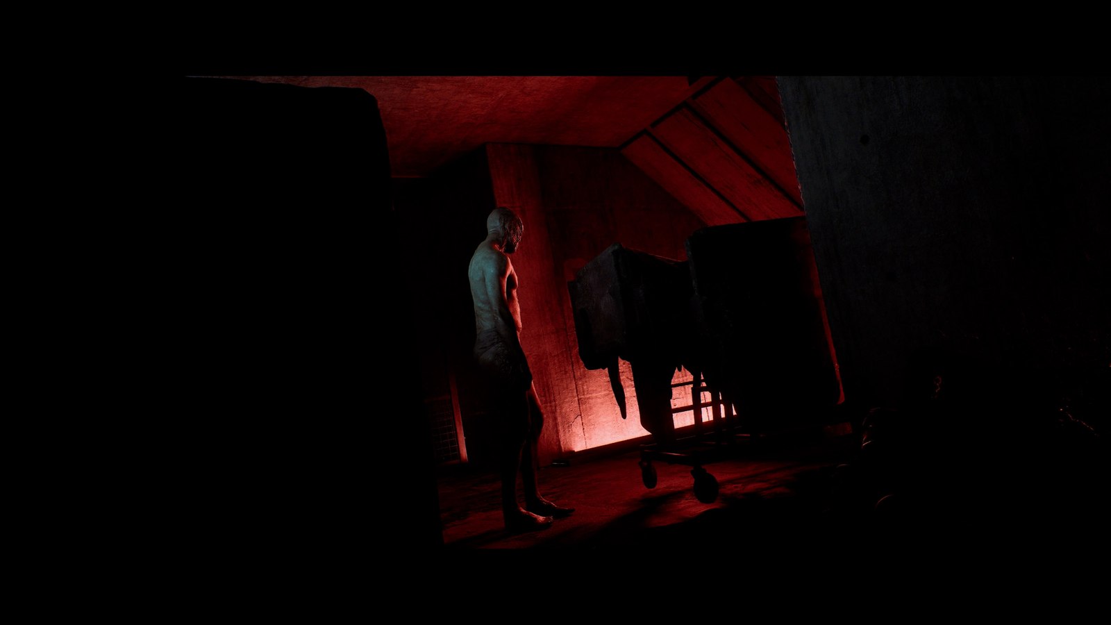 Simon approaches a figure inside a dark room
