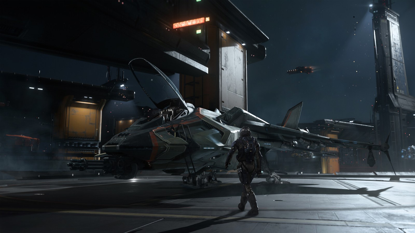 Un piloto camina hacia una nave en un hangar de Squadron 42