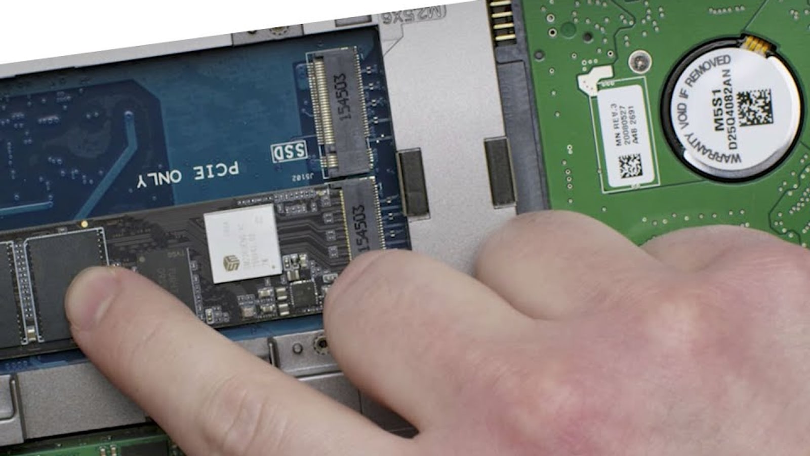 An M.2 NVMe SSD being installed in a laptop