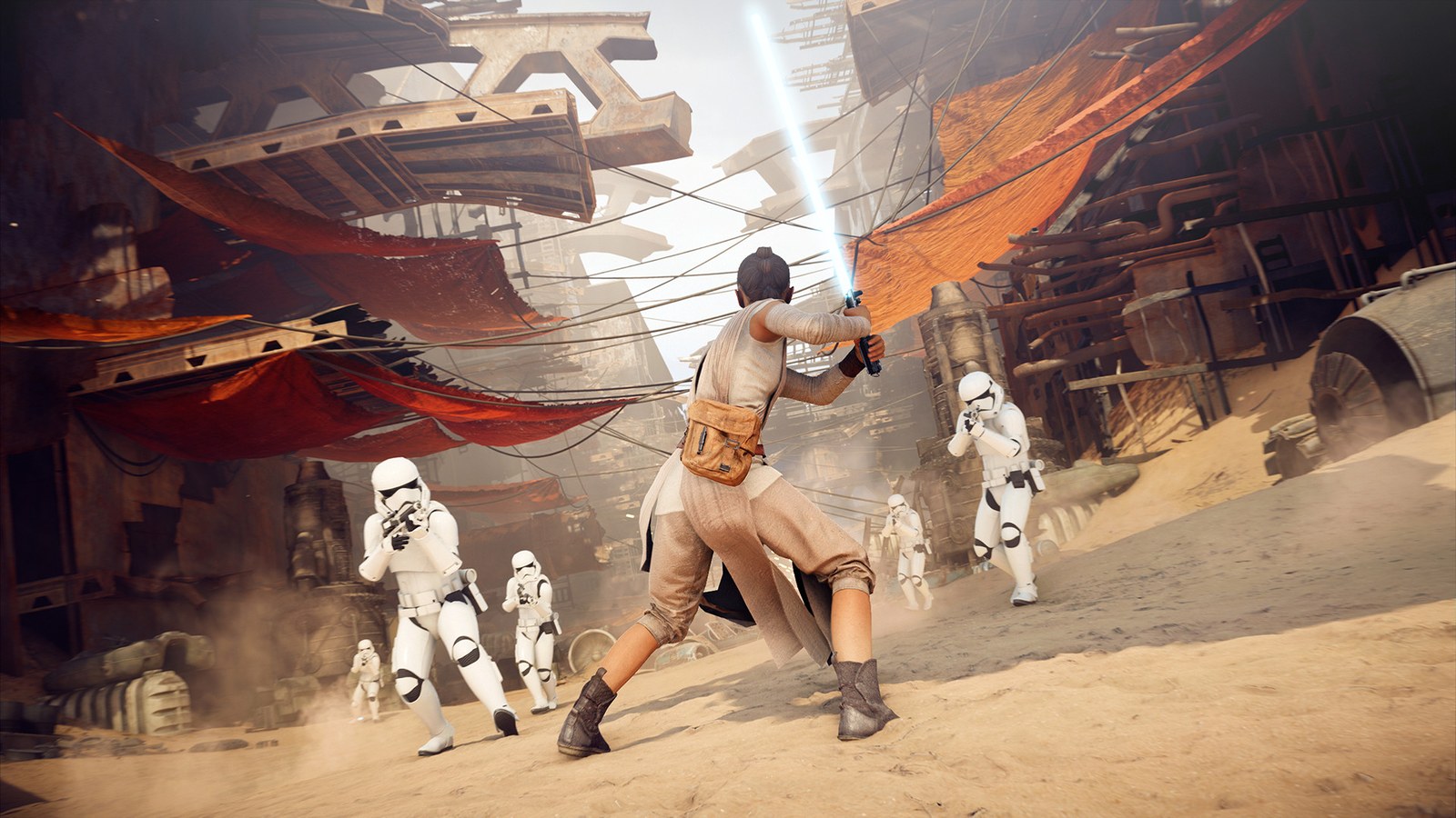 Rey raises her blue lightsaber against a group of stormtroopers in a Jakku settlement in Star Wars Battlefront II