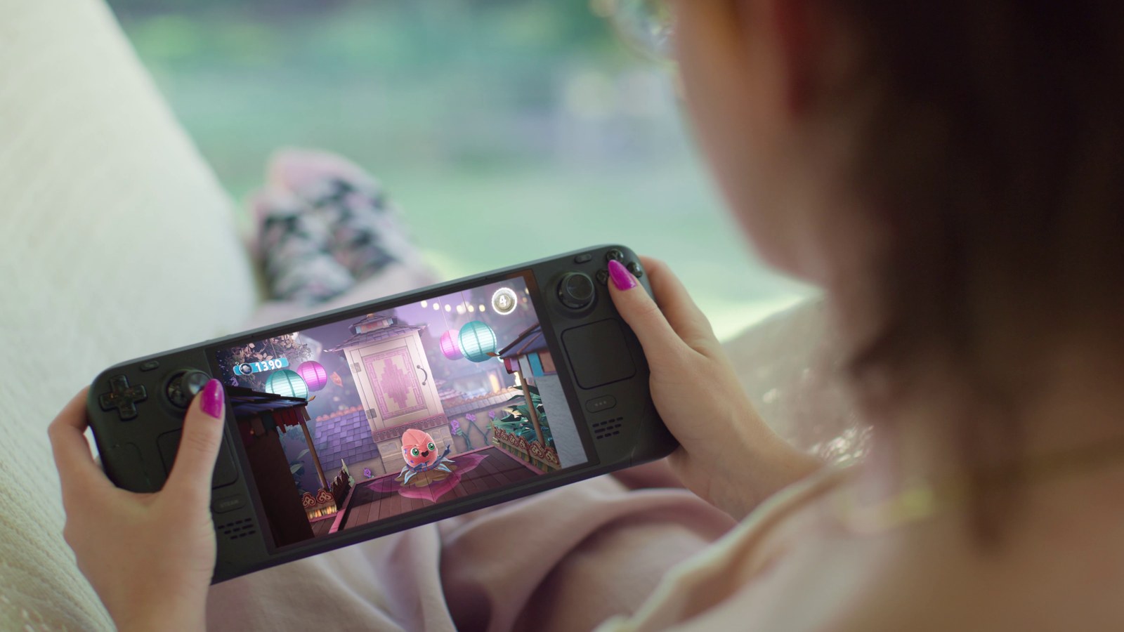 A player holding Steam Deck OLED with Sackboy on screen