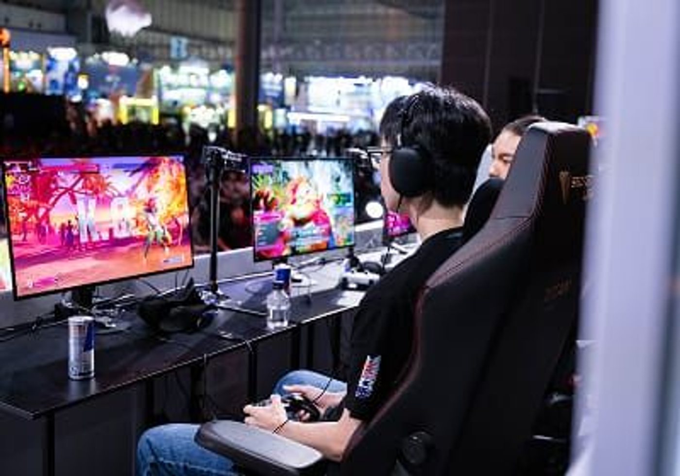 A visitor plays with a controller in a Tokyo Game Show demo area